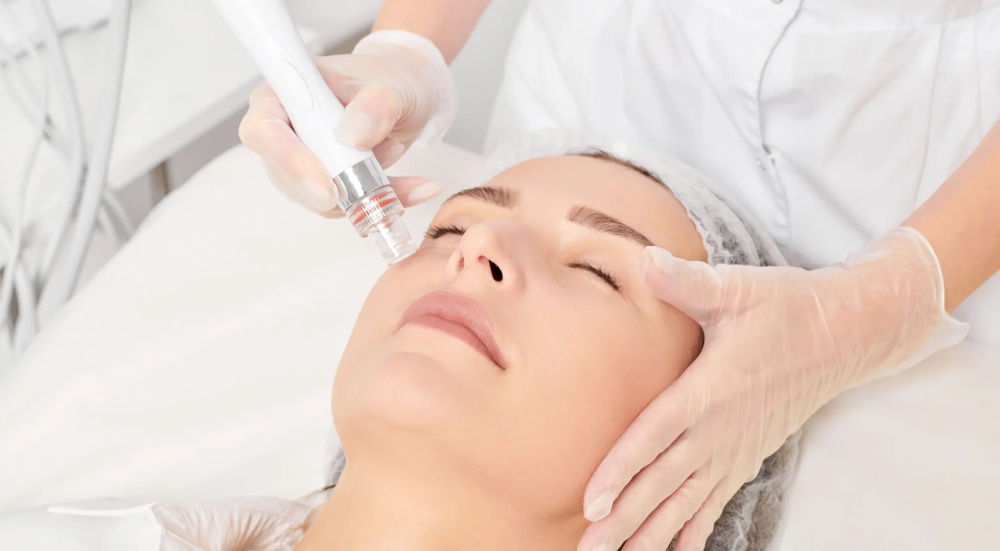 Esthetician performing a facial treatment at Luxura Spa